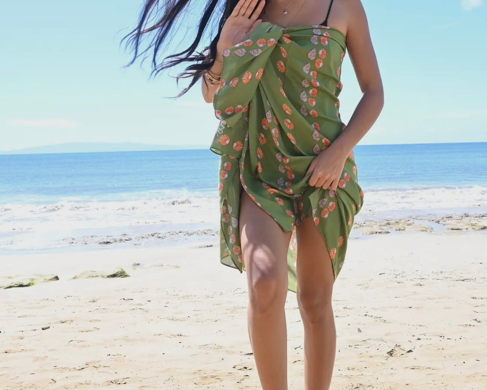 Shell picker on green pareo worn by model - photo from vendor