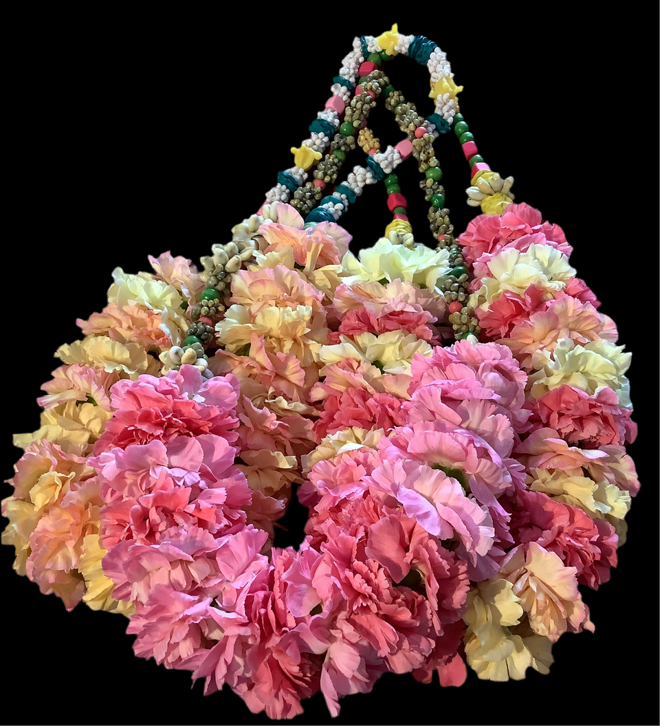Tree examples of the Priscilla lei on a black background