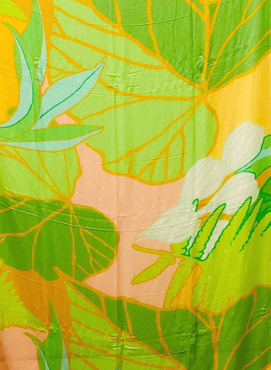 detail of fabric gorgeous tropical greens, golds, pink, a aqua