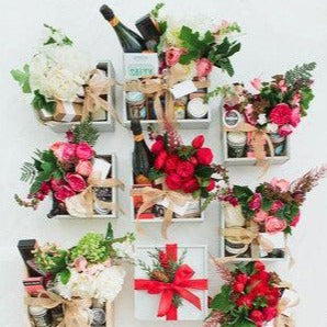 Multiple Baskets with flowers and bottles 