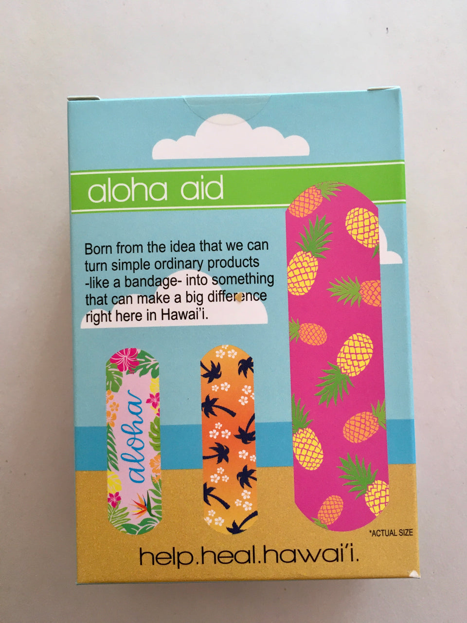 back of aloha aid box. features the three prints.