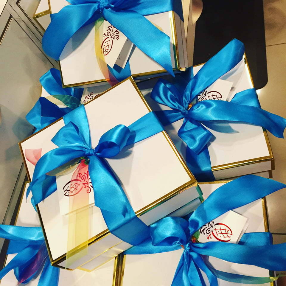 stack of white boxes with blue ribbons