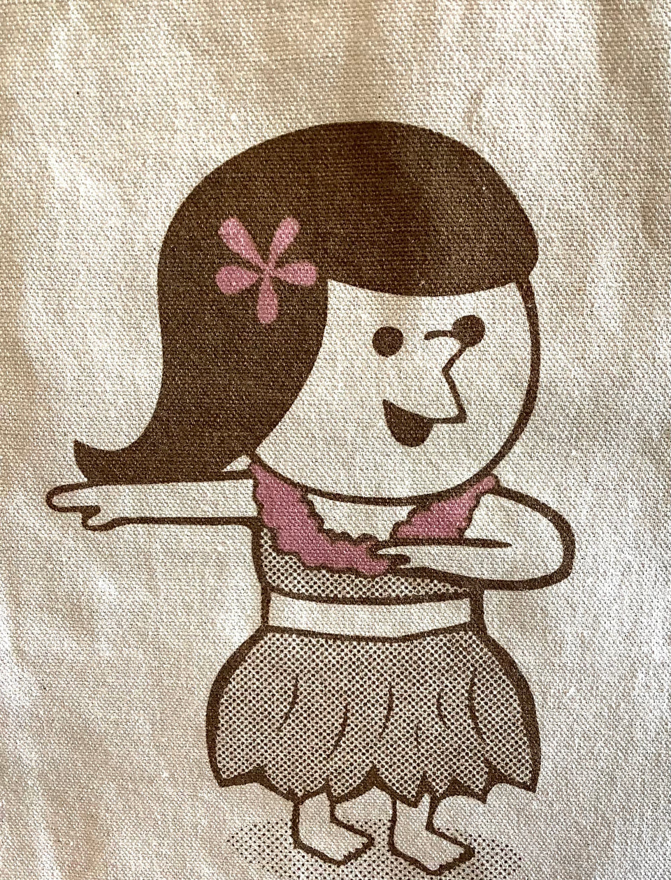 Showing design detail of hula girl on cotton tote