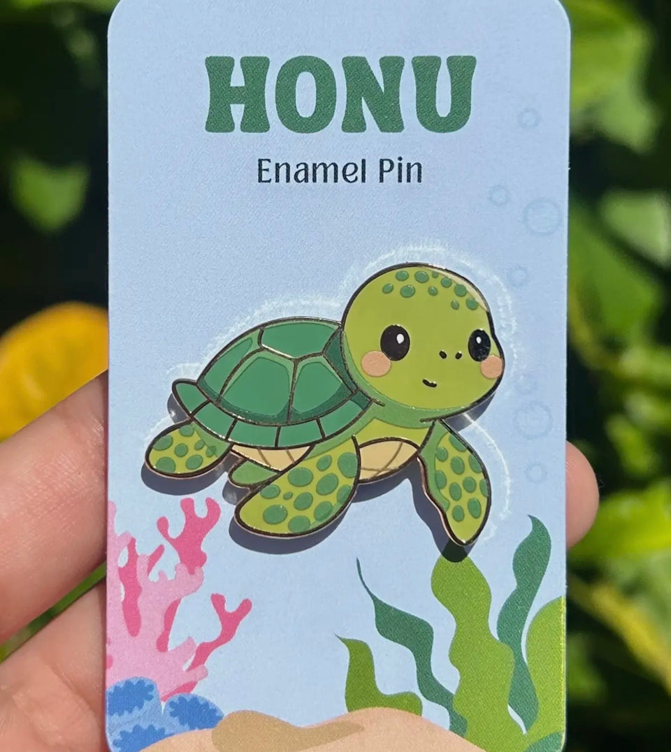Enamel pins made by artist Mahea Leah