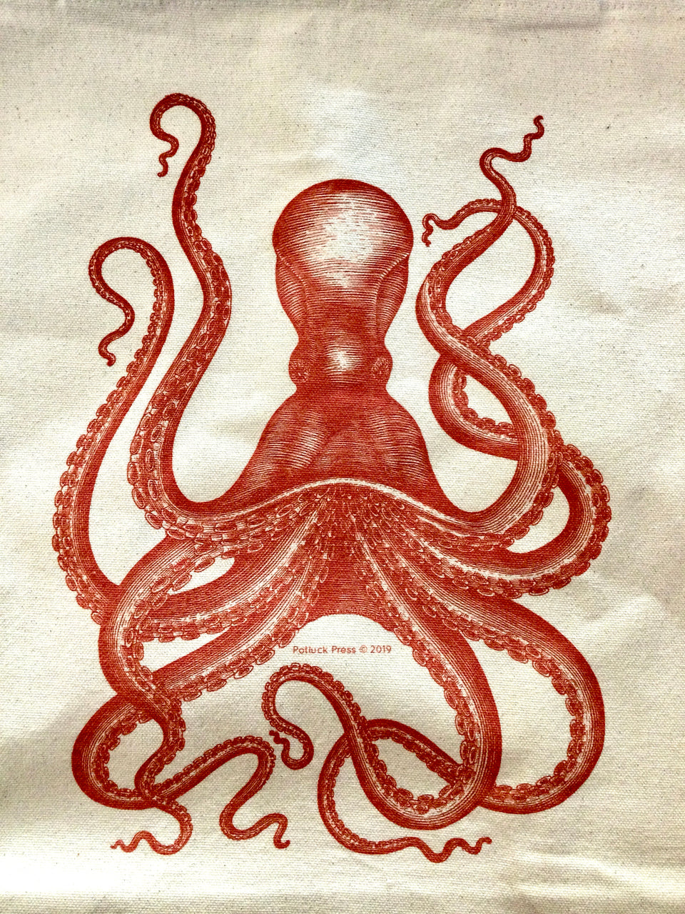 Detail of design rust octopus on a canvas tote