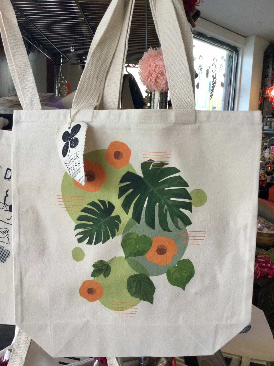 Cotton canvas tote with Green and orange monstera leaf design 
