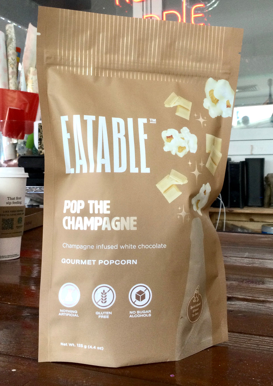 Package of champagne infused popcorn on the desk