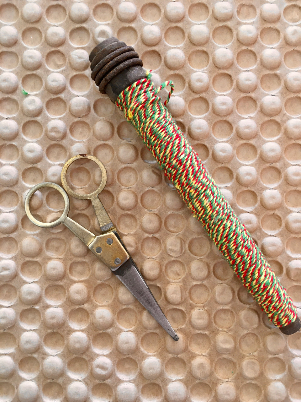 scissors and wooden spool with yarn detail