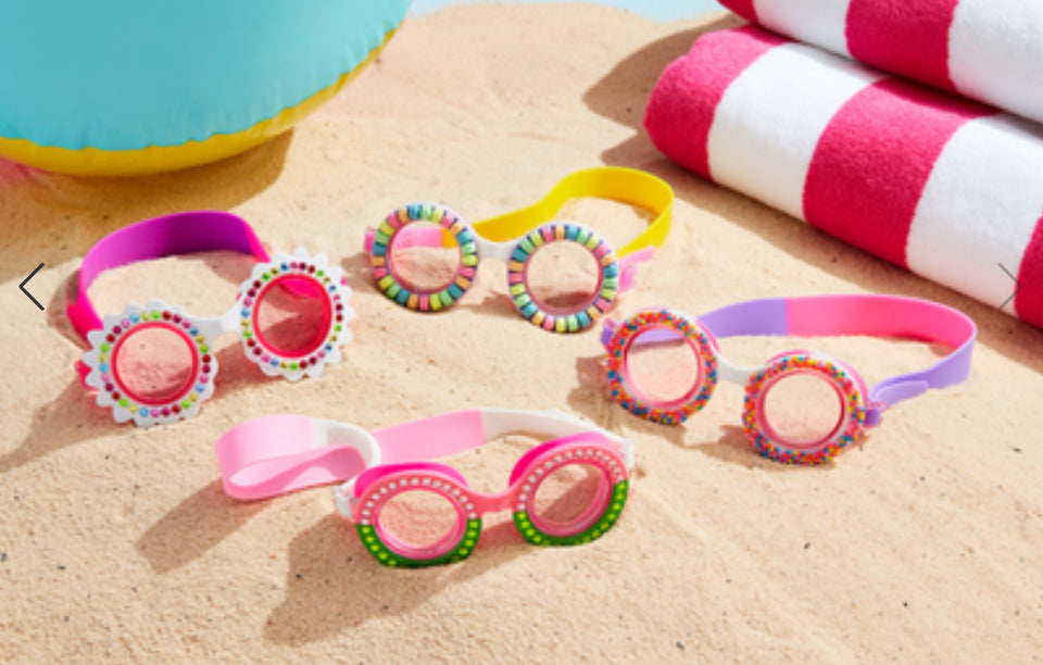 Four sets of fun swim goggles sitting on beach - photo from Mud Pie