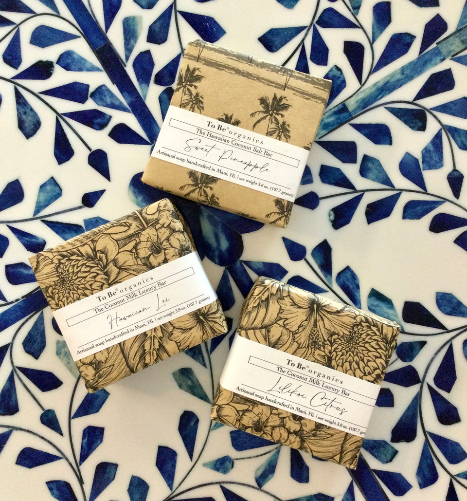 Showing 3 different soaps on a blue and white tilled background