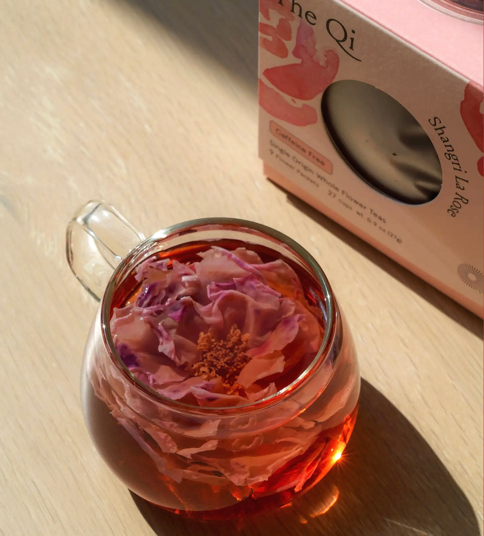 Close up of rose tea blooming in clear cup