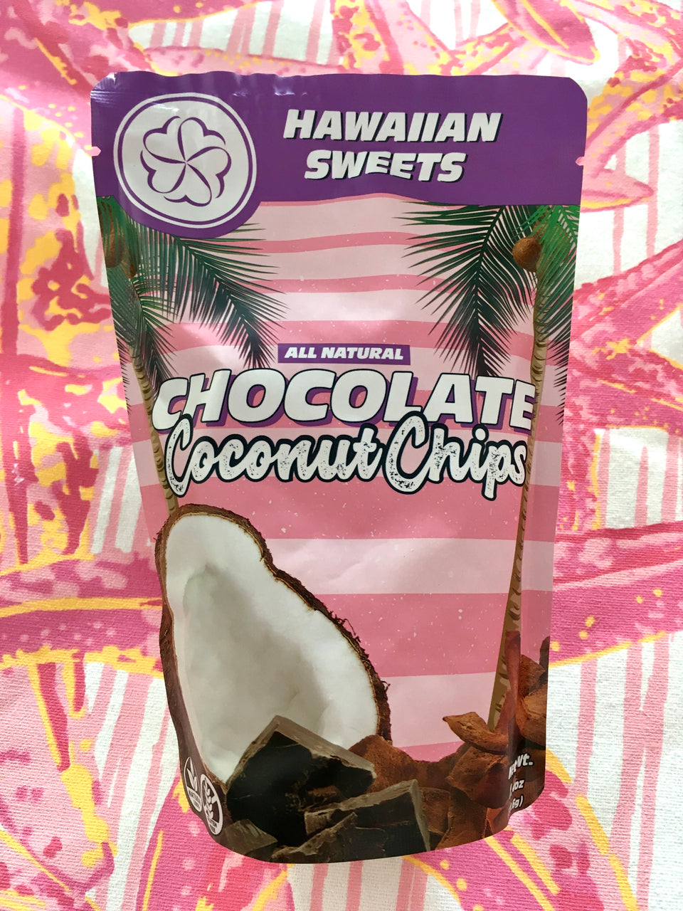 package of chocolate coconut chips on a pink and orange background