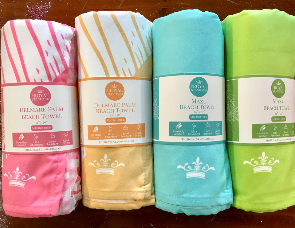 showing 4 rolled beach towels  in packaging