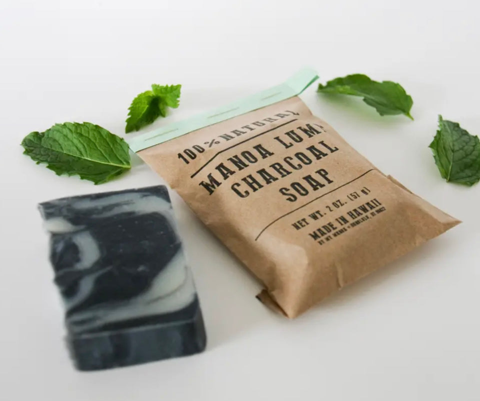 photo shows bar of soap out of package laying by a packaged soap with peppermint leaves 