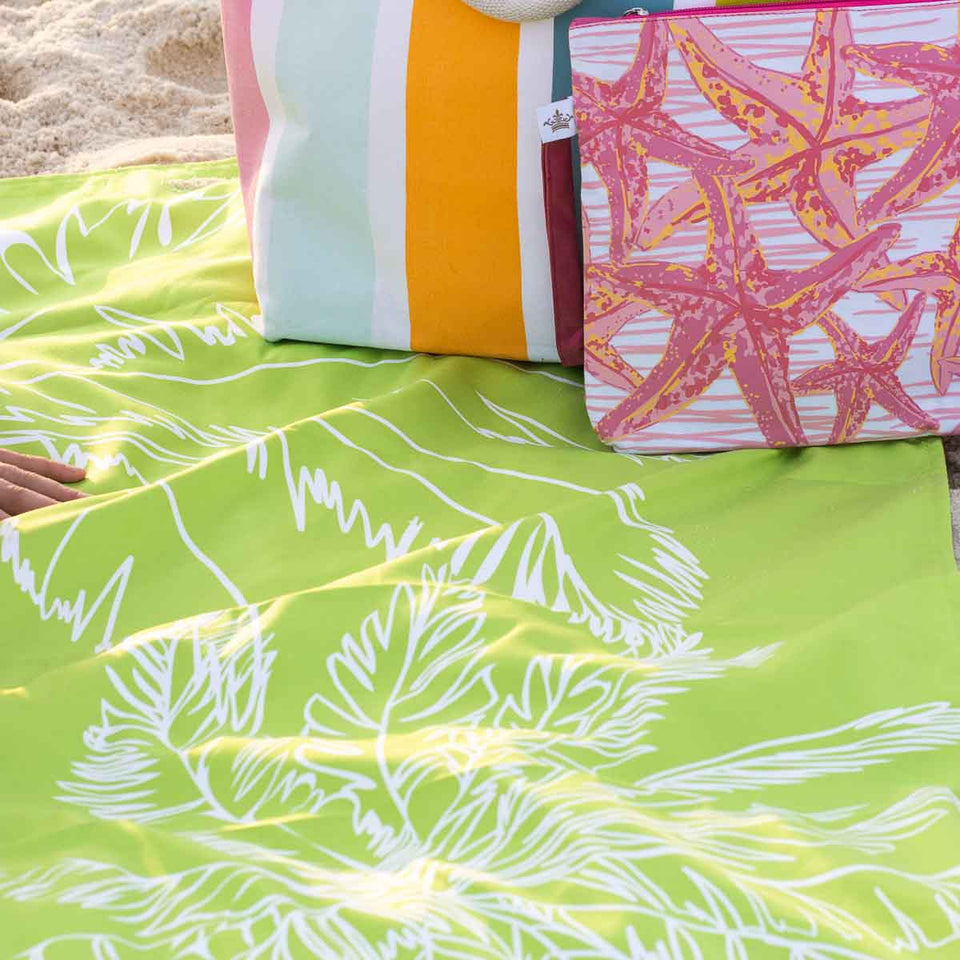 shows green palms towel in use at the beach