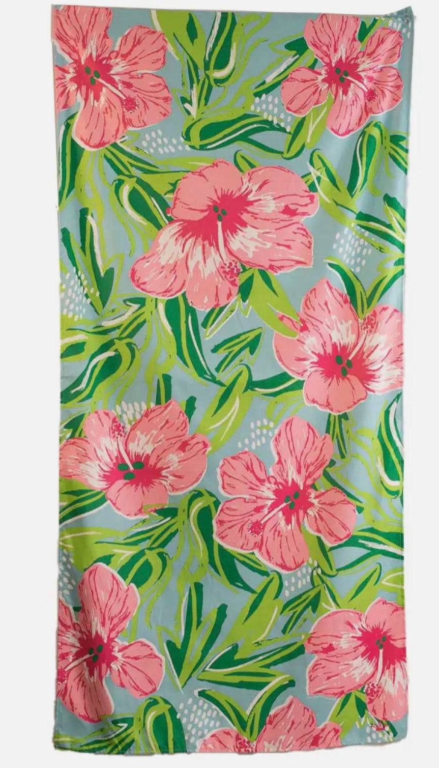 full view of pattern on beach towel - pink hibiscus green leaves on a blue background