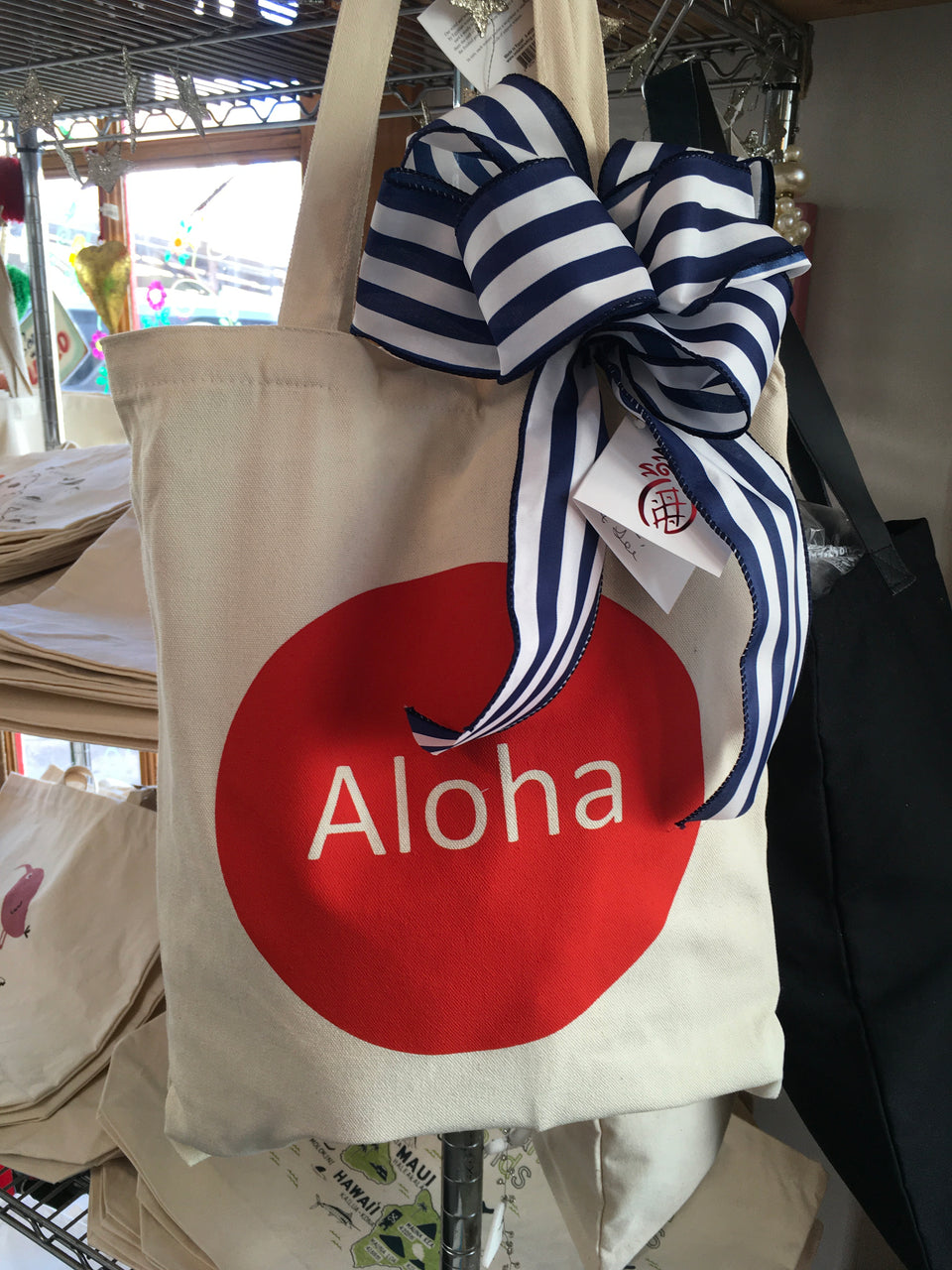 red aloha tote with ribbon and gift tag