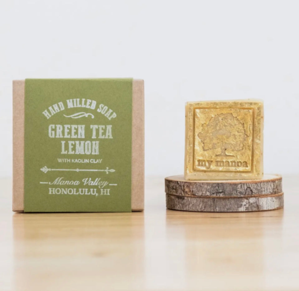 green tea lemon soap in pacge next to the product out of packaging 