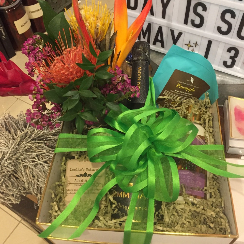 Box with fkowers and gifts sticking out with a big bow