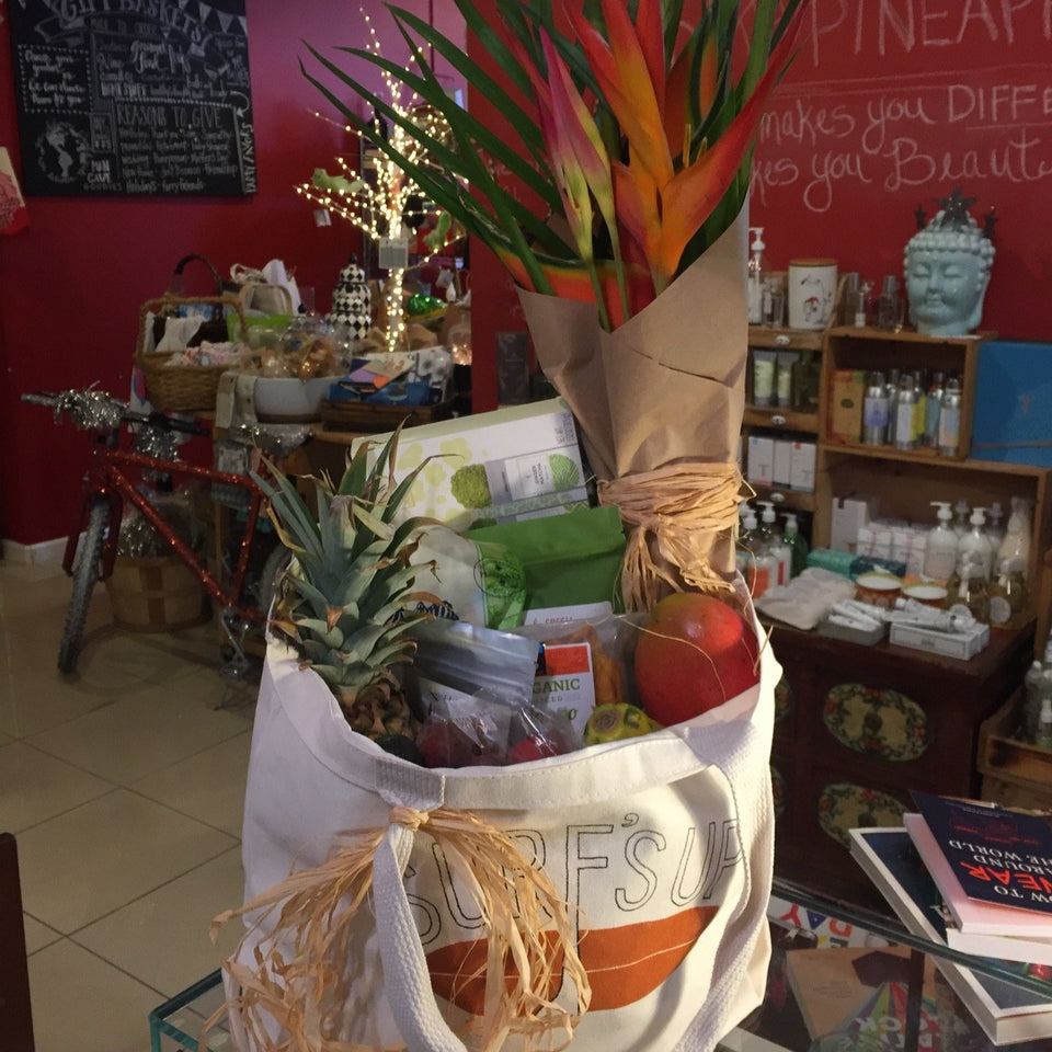 tote bag filled with fruit and a fresh flowers sticking out