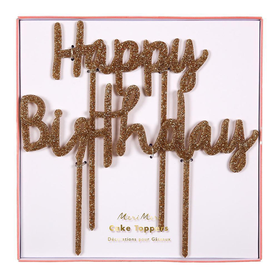 Gold glitter acrylic cake topper that says happy birthday
