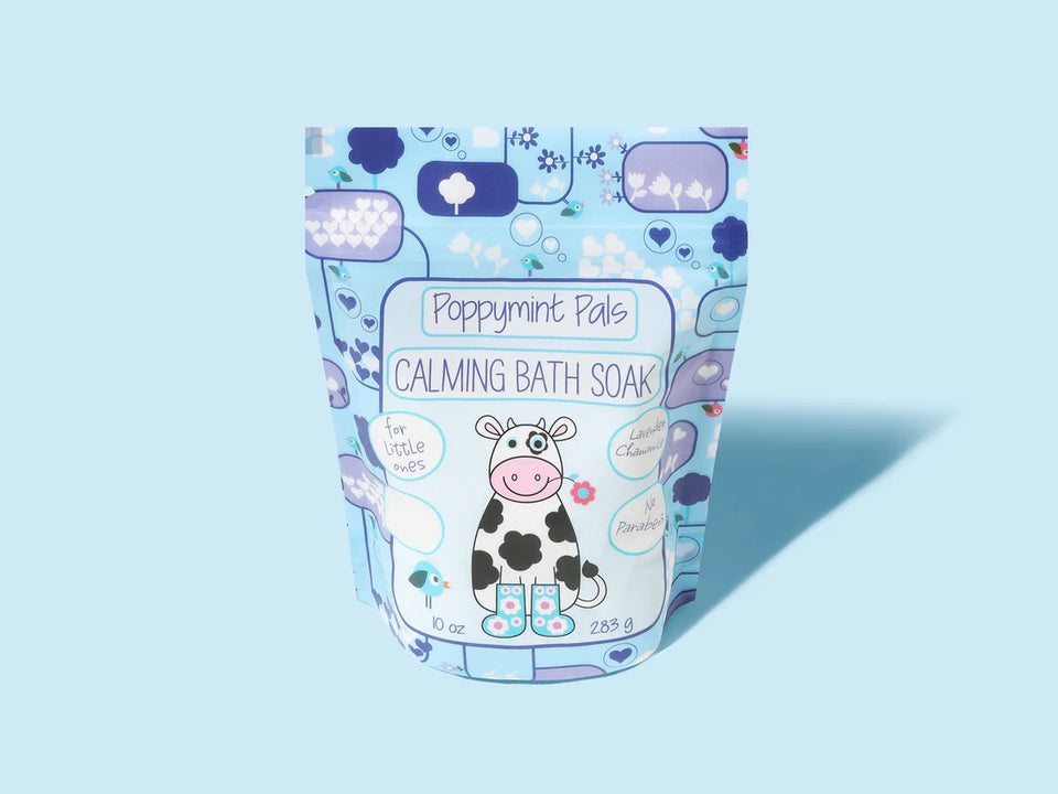 blue bag of calming bath soak with a cow on the front