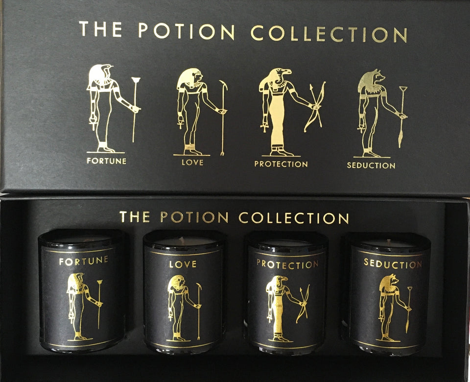 box of four black candles with egyptian graphics