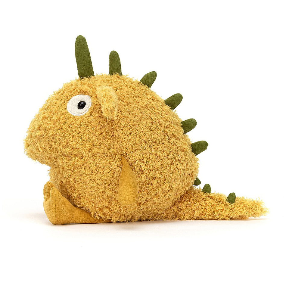 happy yellow stuffed monster with green horns