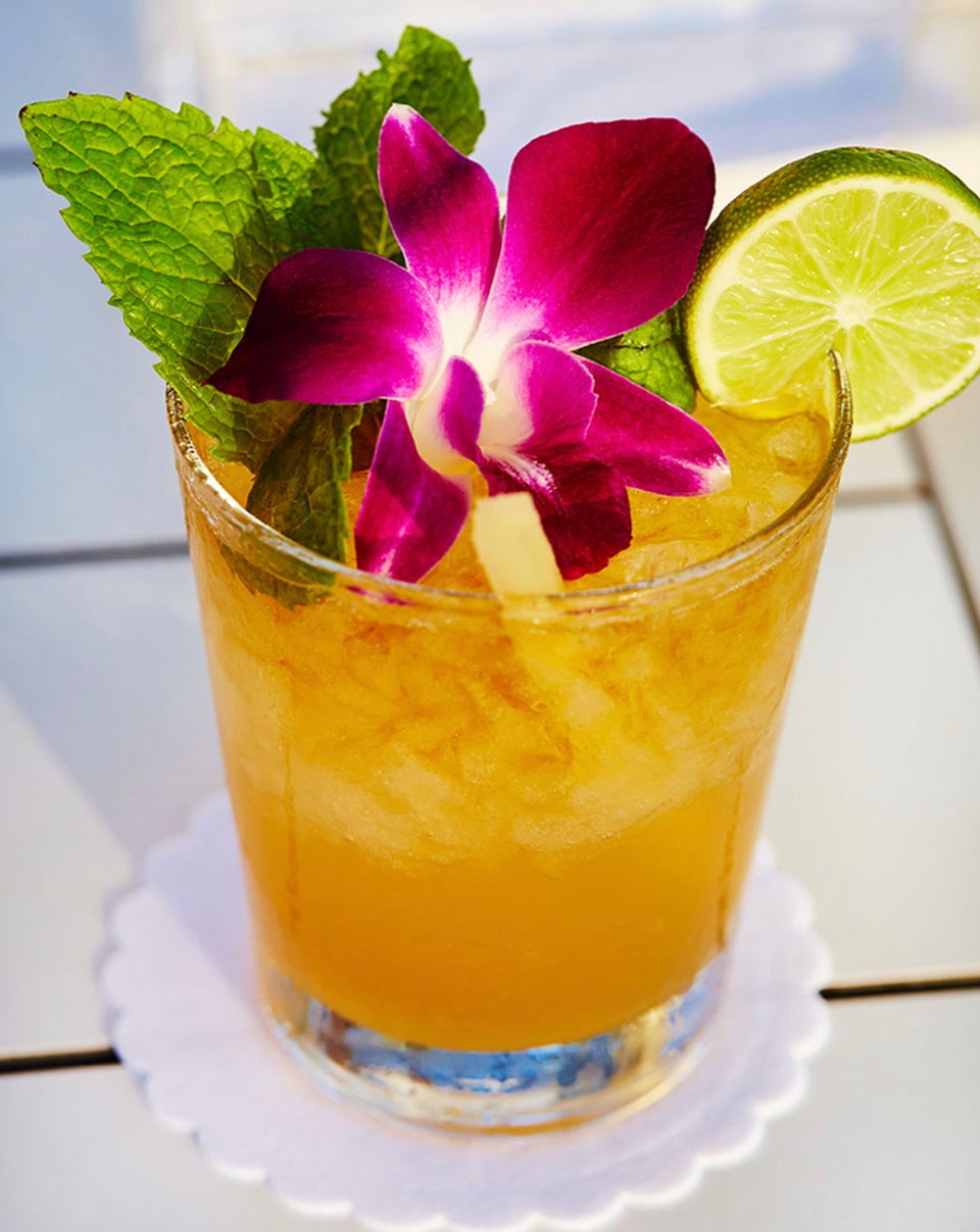 picture of a tropical cocktail with a flower