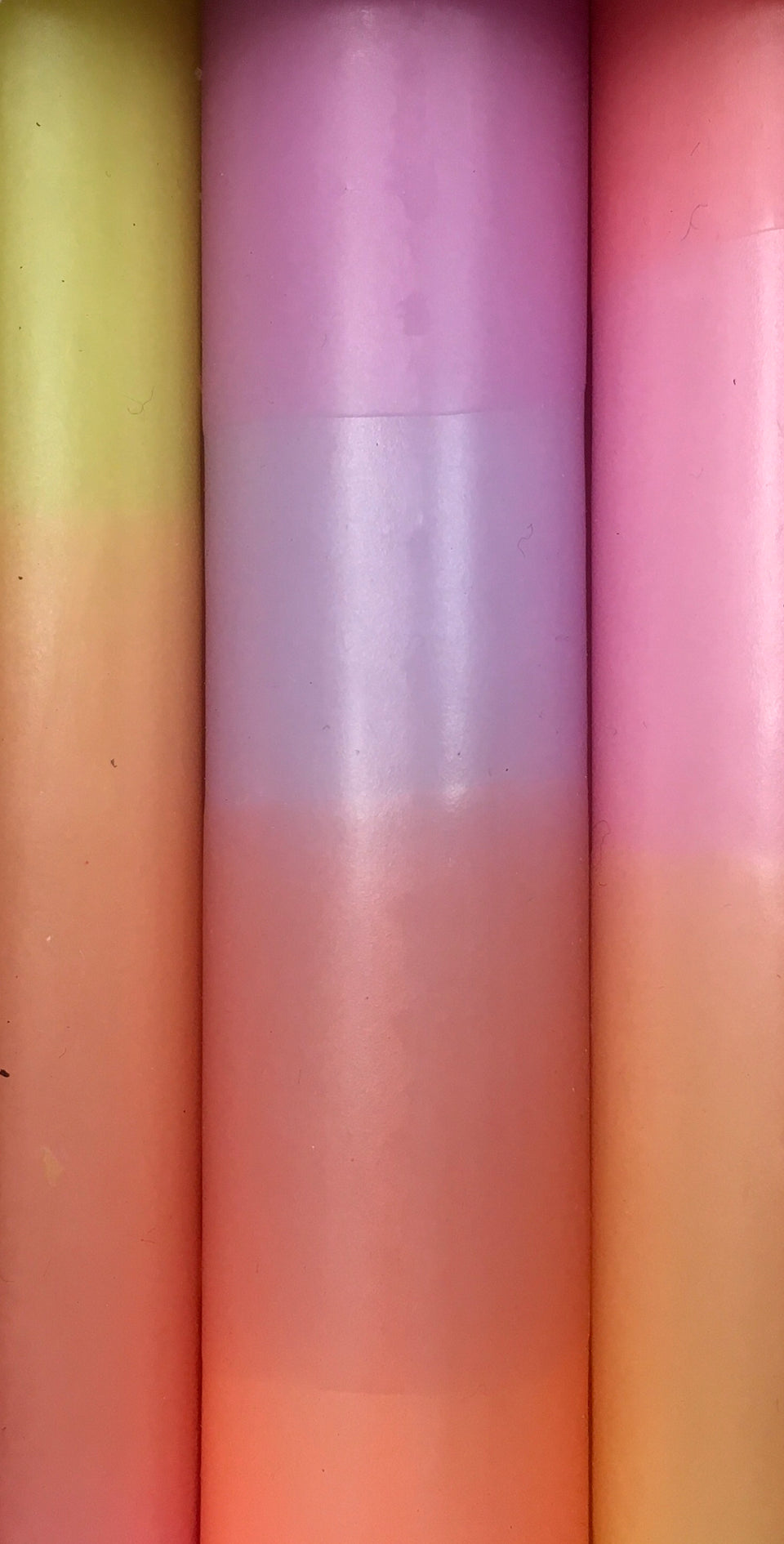 Close up of pink and orange rainbow candles