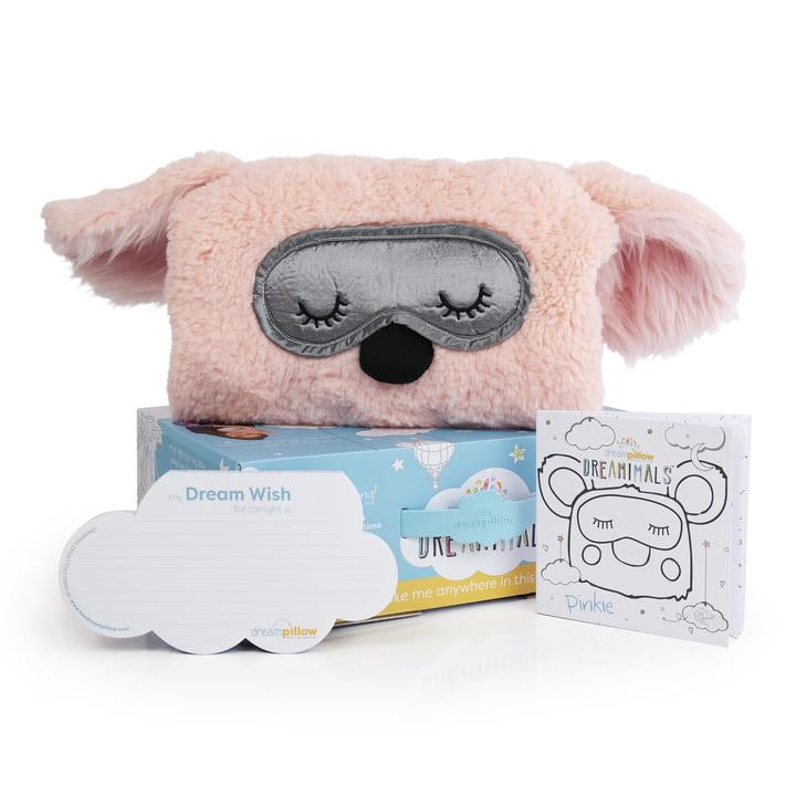 close up of pink dog pillow with coloring book and box