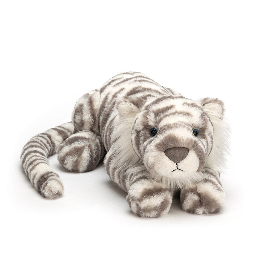 white stuffed snow tiger laying down