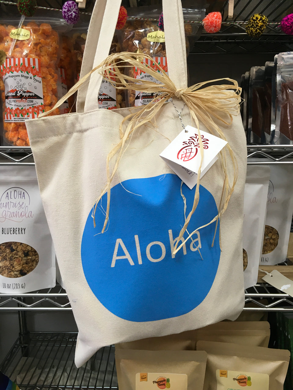aloha canvas gift tote tied with rafia and the red pineapple gift tag