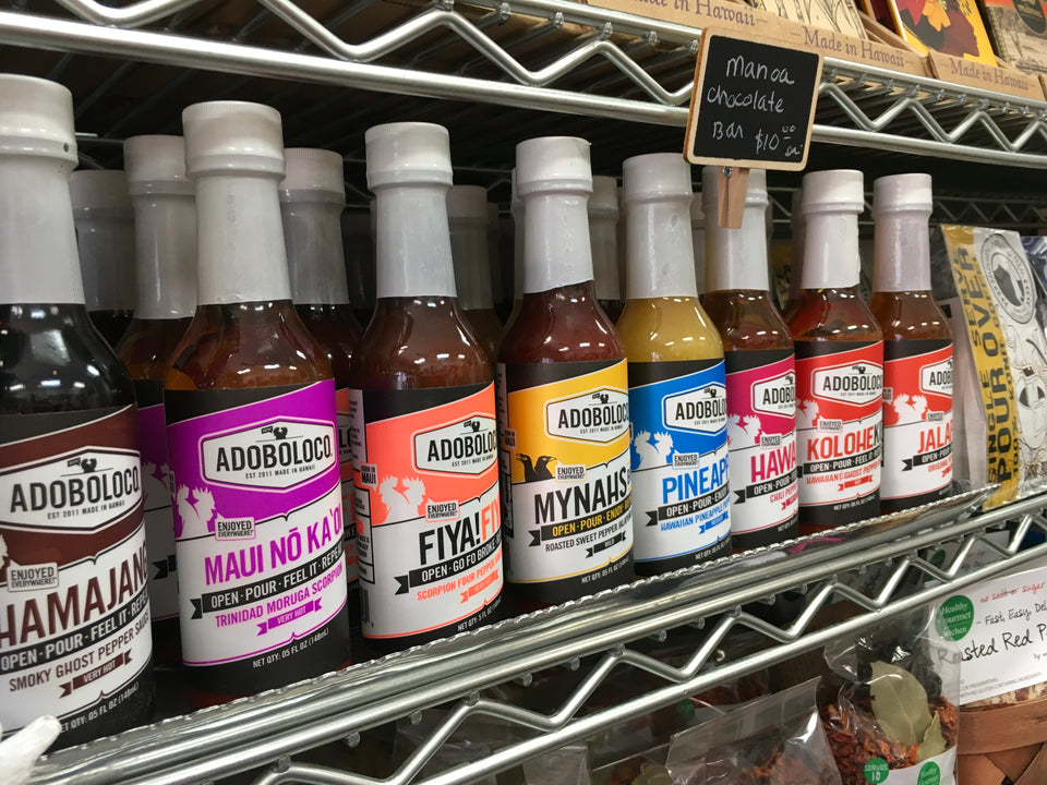 An angled photo of all the hot sauces on shelf.